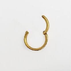 Alternative view of Clicker de titanio con baño de oro y 3 hileras de zirconias