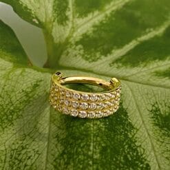 Clicker de titanio con baño de oro y 3 hileras de zirconias